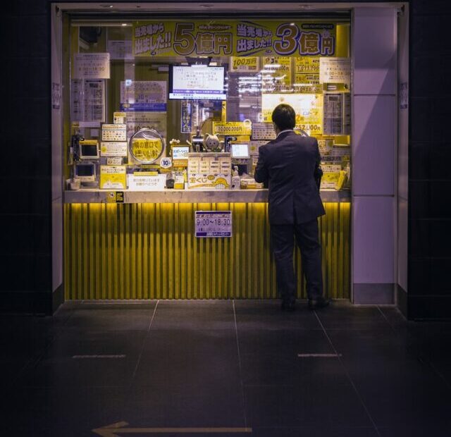 a man standing in front of a store front