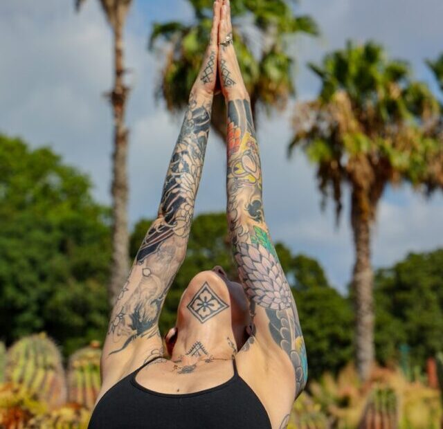 woman in black bikini with blue and black tattoo on her back